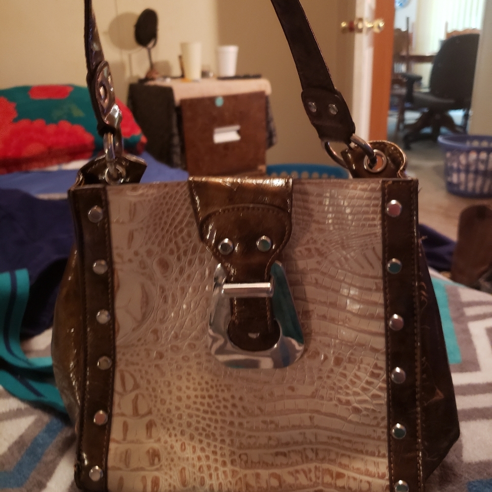 brown and tan Michael kors purse.